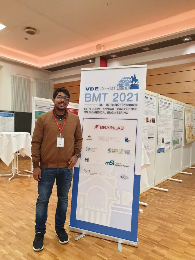 Himanshu Kumar beside the BMT 2021 conference banner in Hannover