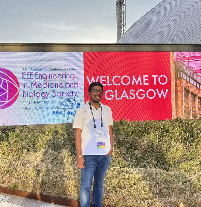 Himanshu Kumar at the IEEE EMBC 2022 welcome banner in Glasgow