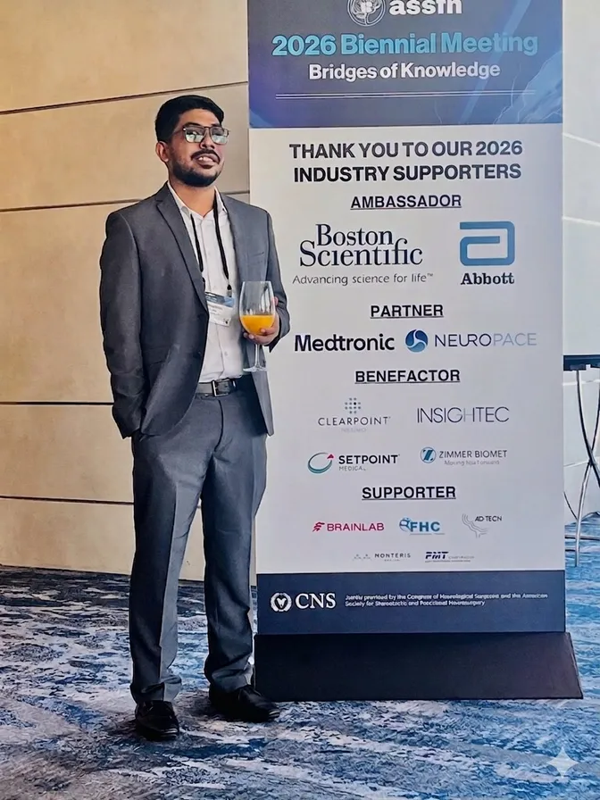 Himanshu Kumar beside the ASSFN 2026 Biennial Meeting banner